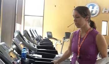 Team member Rachael taking a look at the Horizon Adventure 3 Treadmill at company headquarters.