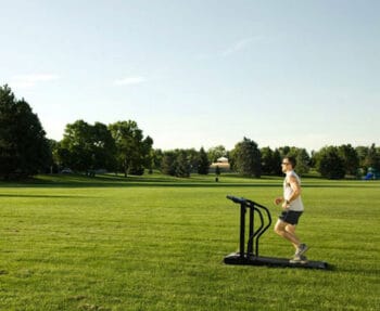 a treadmill in the middle of a grass field